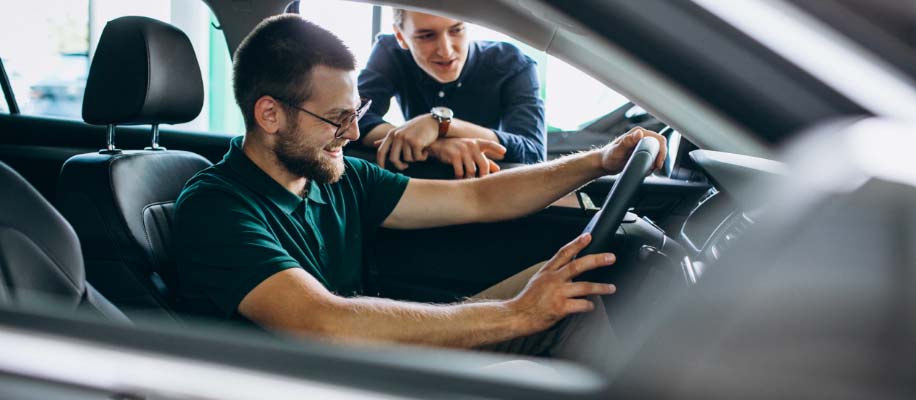 Person_sitting_in_drivers_seat_at_dealership%402x.jpg